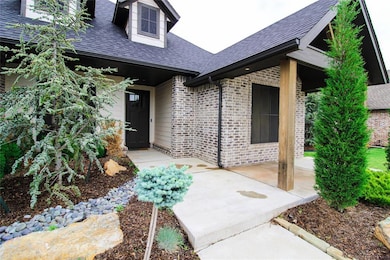 Entrance to property featuring brick siding, roof 