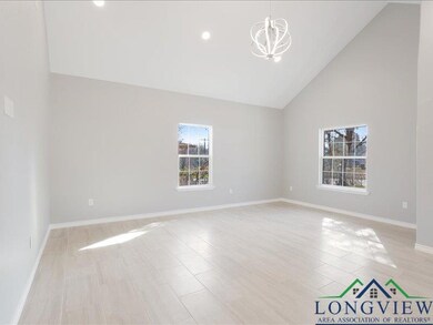 Spare room with baseboards, high vaulted ceiling, 