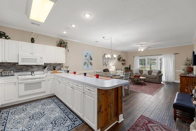 Kitchen with dark hardwood / wood-style floors, ce