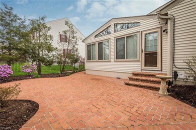 Brick patio off the enclosed porch provides space 