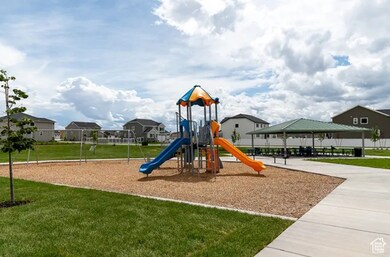 Community jungle gym featuring a lawn and a residential view