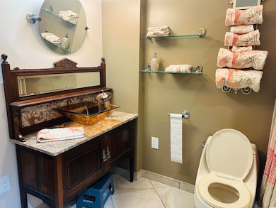 Half bathroom featuring light tile patterned floors and vanity
