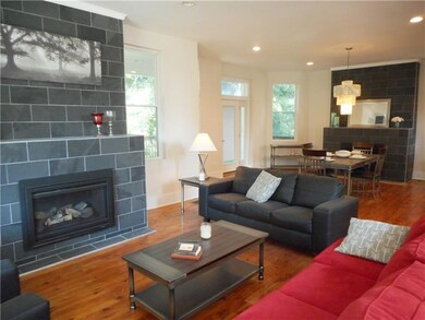 Living room: Two gas fireplaces, warm wood floors,
