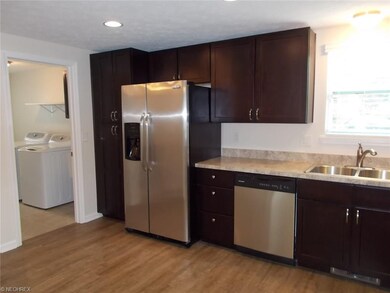 Laundry room is adjacent to the New Beautiful Kitchen.  Large Pantry to the left of the refrigerator.  All New Stainless Steel, Frigidaire appliances.