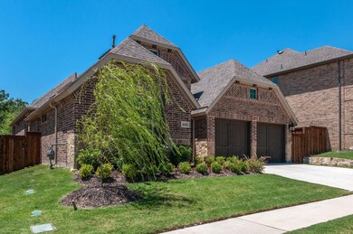View of front of house featuring a garage and a front yard