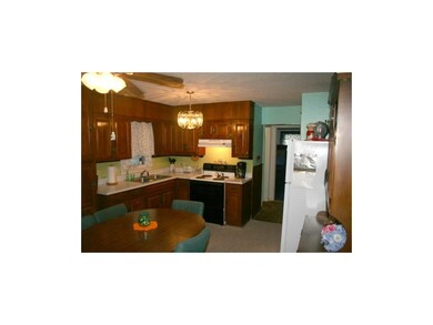 open kitchen with stained cabinets