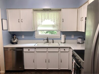 The kitchen is clean and crisp with it's white cab