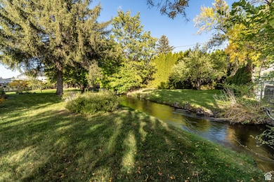 View of grassy yard with a water view