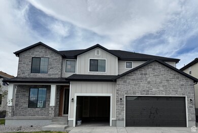 View of front of home featuring concrete driveway, stone siding, board and batten siding, a porch, and an attached garage