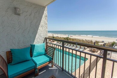 Balcony with a water view and a beach view