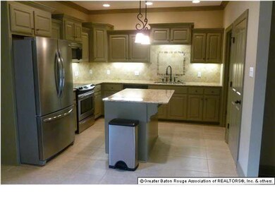 Kitchen has granite counters, double stainless ste