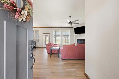 Living room with ceiling fan, a tile fireplace, an