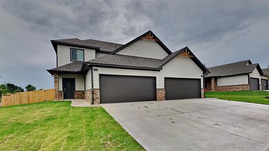 View of front of home with a shingled roof, a garage, brick siding, and driveway