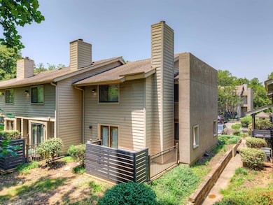 Rear view of property with a chimney and roof with shingles