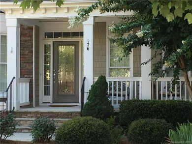 Lovely mature landscaping, pretty front porch, and
