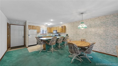 Lakefront 5-bedroom, 3.5-bath Lazy Days Condo in Osage Beach. Two levels of open living with panoramic Lake of the Ozarks views, multiple decks, a boat slip, and a hard-to-find garage option
