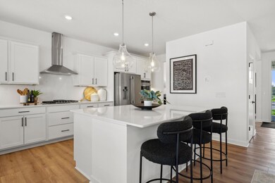 (Photo of a decorated model, actual finishes will vary) The center island extends out to a breakfast bar for casual meals