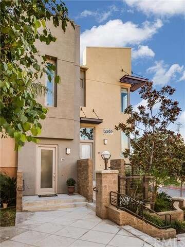 Front door opens onto landscaped plaza