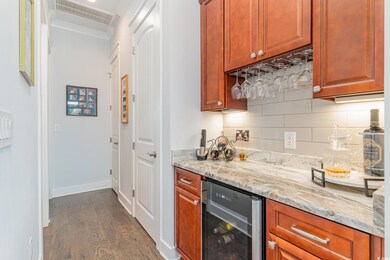 Kitchen with tasteful backsplash, dark wood-type f