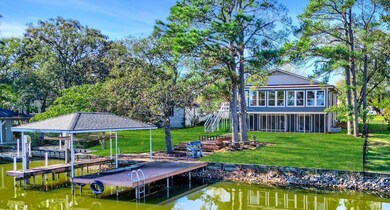 View of dock featuring a water view and a lawn