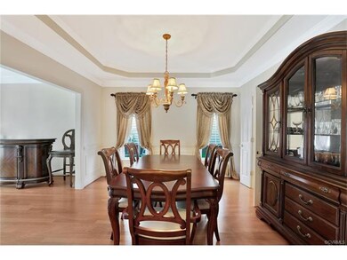 Formal Dining Room with hardwood floors, tray ceil