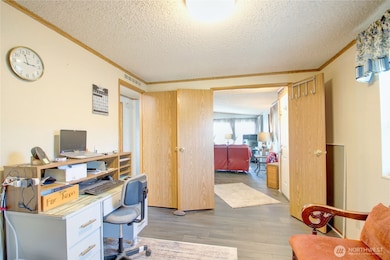 Spare room has double doors to the living area and door to the left enters into the hallway.