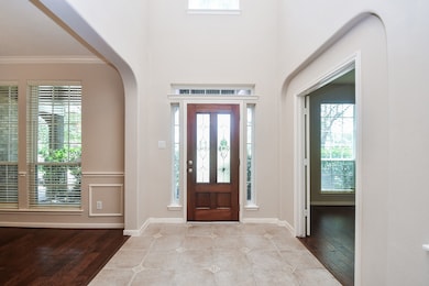 This entryway features a tall, elegant front door