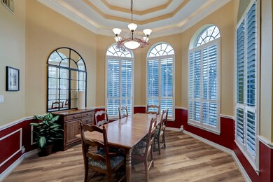 The room is enhanced by a
captivating chandelier, custom paint, high ceilings, and chair rail.