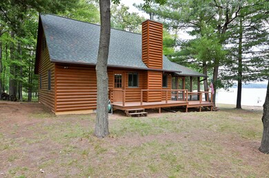 The main entrance to the cabin is along the side that includes a porch.