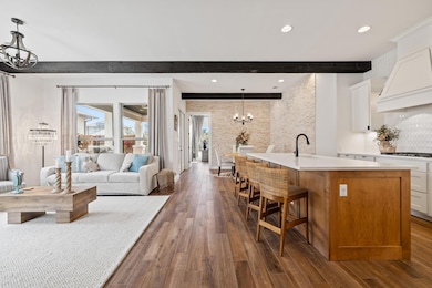 The upgraded home is adorned with custom lighting, extra windows welcoming in an abundance of sunshine, wooden beams and so much more.