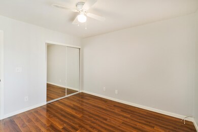 BEDOROOM WITH MIRRORED CLOSET DOORS