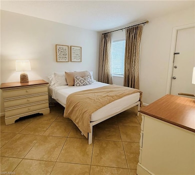 Bedroom featuring light tile patterned flooring an