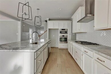 So beautiful!  Granite and a 5-burner gas cooktop.