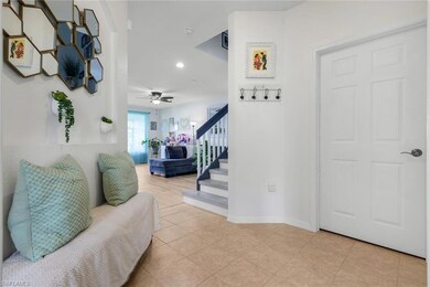 Entryway featuring stairs, recessed lighting, light tile patterned floors, and a ceiling fan