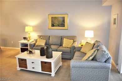 Living area with baseboards and carpet flooring