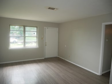Unfurnished room featuring wood finished floors and baseboards