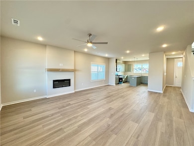 This open living room is a warm and inviting space that combines modern design with cozy comfort.
