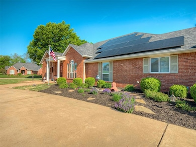 Single story home with brick siding and roof mounted solar panels