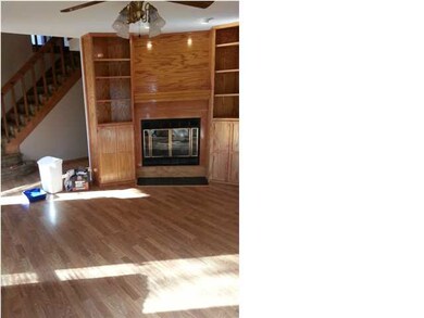 LIVING ROOM W/FIREPLACE AND BUILT-IN BOOKCASES