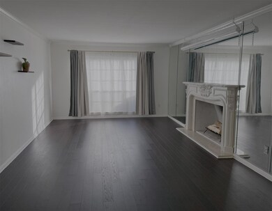 Bright living room with dark hardwood floors, feat