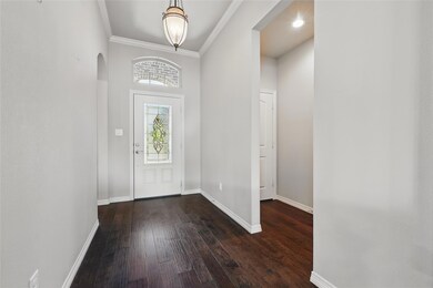 Entryway with arched walkways, crown molding, base