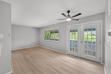 Spare room with wood finished floors, a textured 