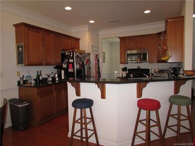 The kitchen also has a breakfast bar area.