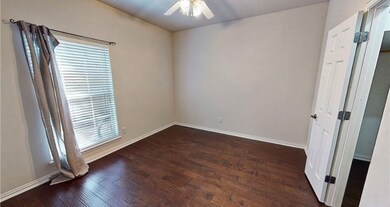 Spare room featuring a ceiling fan, wood finished