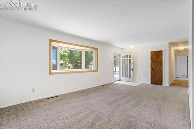 Empty room with carpet and baseboards