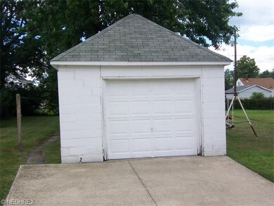 Nicely kept concrete block 1 and a half car garage