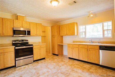 Kitchen leading to inside laundry