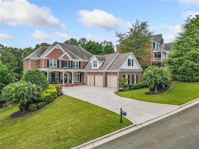 View of front of home with a garage, a porch, and 