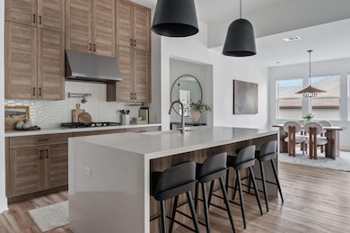 Kitchen featuring a sink, light wood-style floors