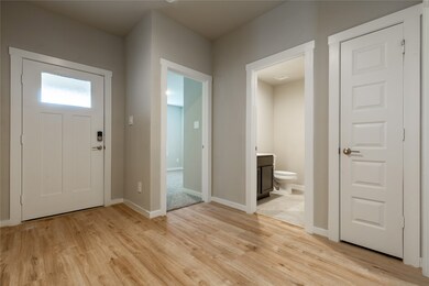 Welcoming front entry with guest half bath nearby.